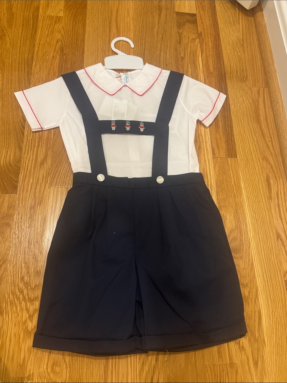 Feltman Brothers Navy Suspender Romper with White Collared Top and Toy Soldiers